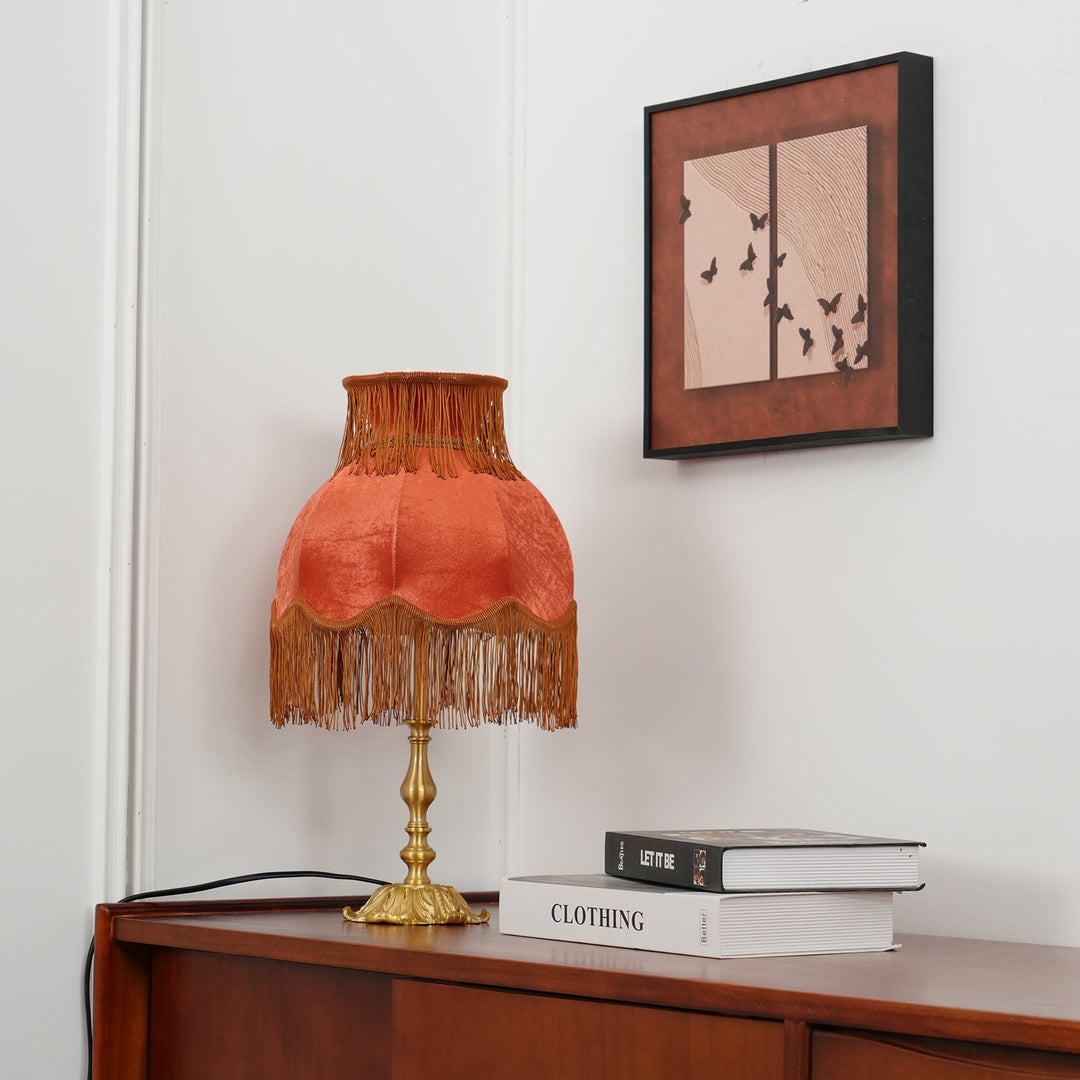 Living room table lamp: warm-toned red bohemian with stylish tassel accent, unique design.