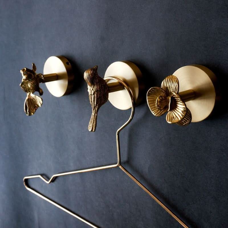 Stylish brass animal coat hook rack with gold accents for entryway organization.