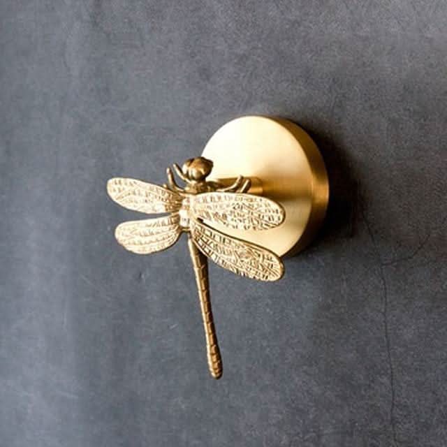 Vintage-inspired brass animal wall hook with gold accents, adds charm to any room.