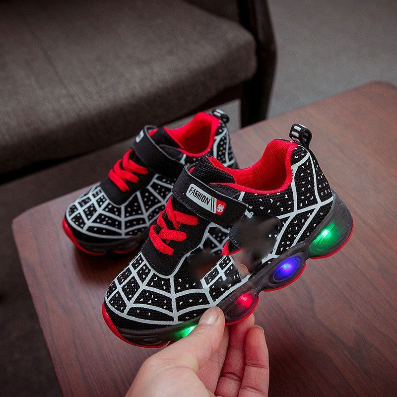 Youth superhero LED sneakers with tough rubber soles, glowing lights & secure velcro closure for playground fun.