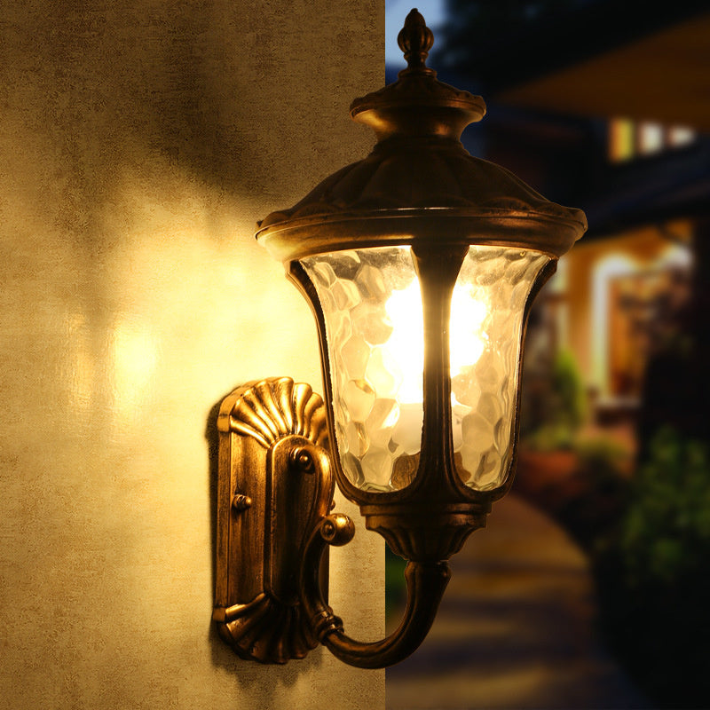 Rustic bronze & black outdoor light fixture with glass shade, weather resistant.