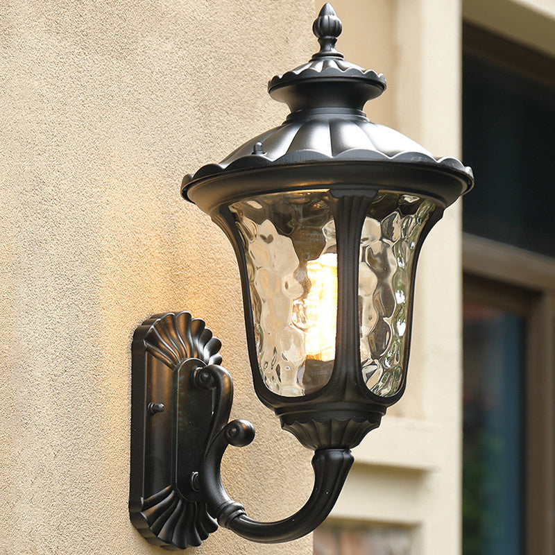 Black & bronze waterproof wall lantern for outdoor use, featuring a glass shade.