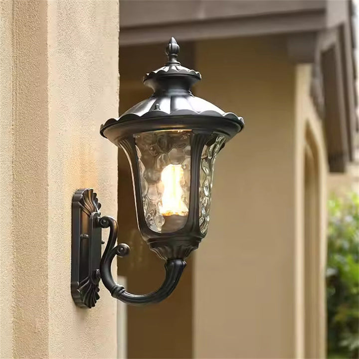 Outdoor wall light, bronze & black finish, glass shade, designed for all weather.