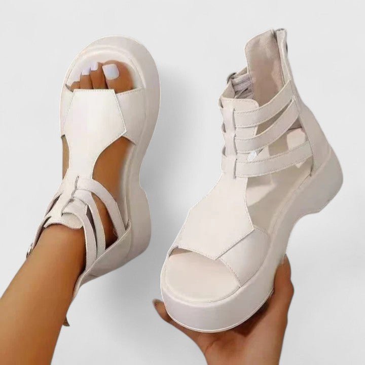 Close-up of women's brown platform buckle gladiator sandals, showcasing the ankle strap & chunky sole.