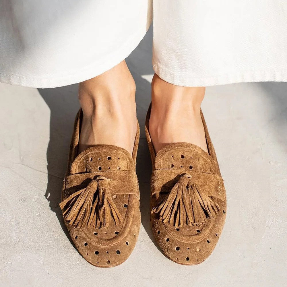 Brown women's perforated tassel loafers. Comfortable slip-on shoes for elegant everyday style.