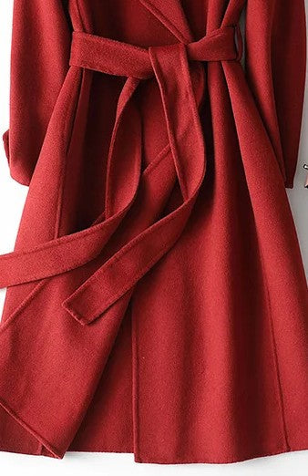 Elegant burgundy women's wrap coat with an adjustable belt & chic notch lapel, offering stylish and warm winter outerwear.