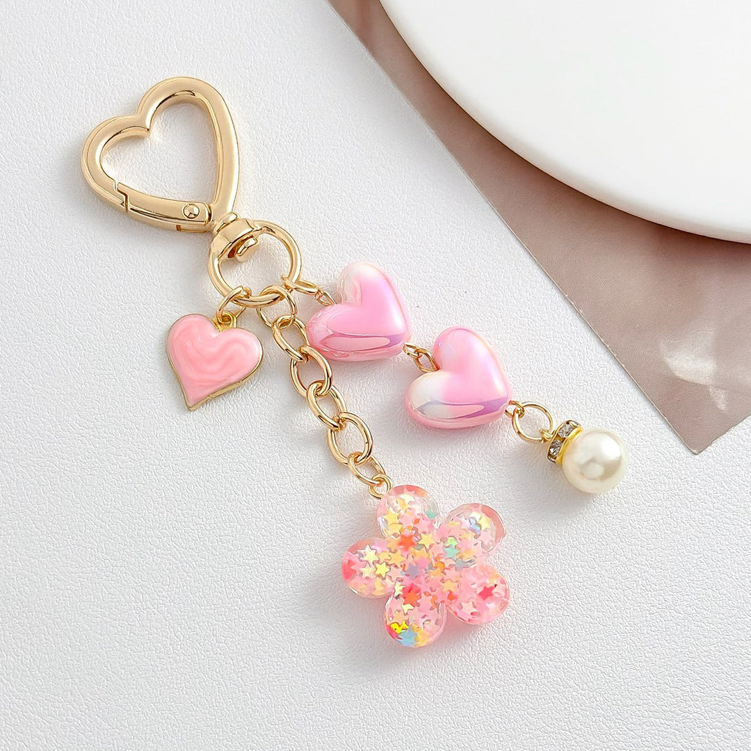 Durable heart, flower & evil eye charm keychain. Stylish accessory for bags & keys, cute gift.