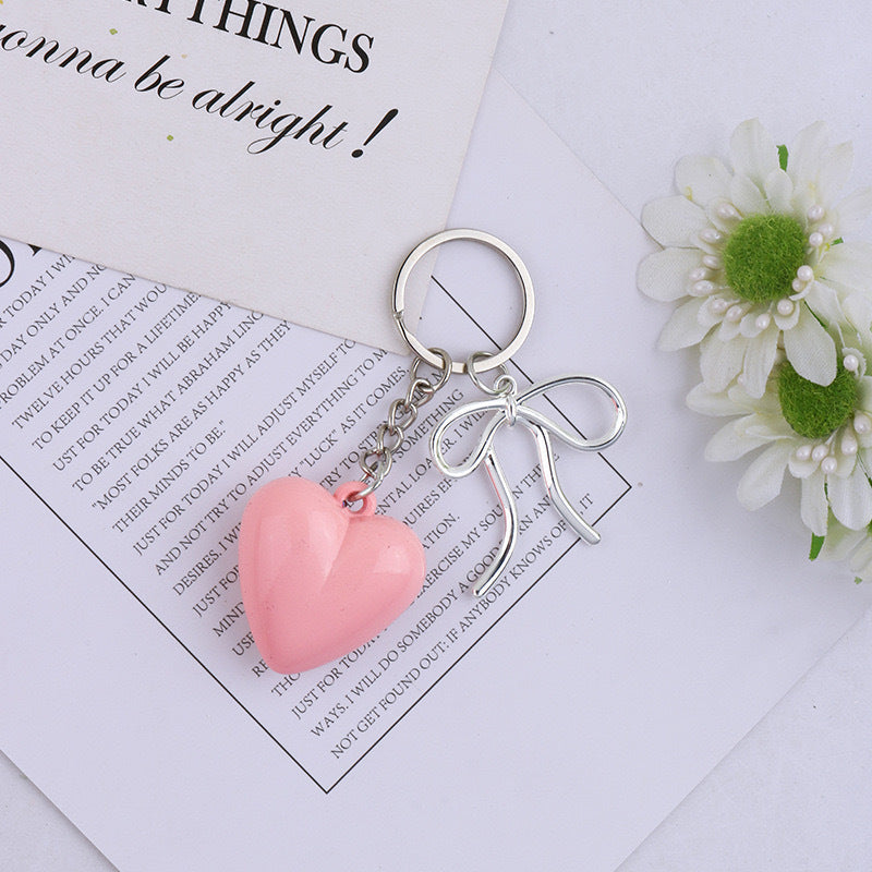 Assorted colorful heart keychains. Charming bag charms & key holders in pink, blue, black, yellow.