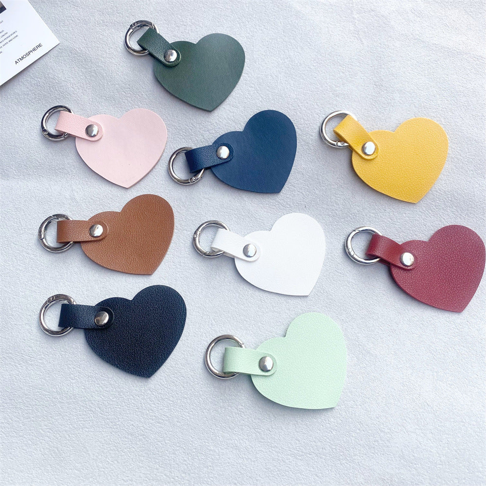 Sophisticated leather heart bag accessory. Elevate your style with this elegant and charming keyring.