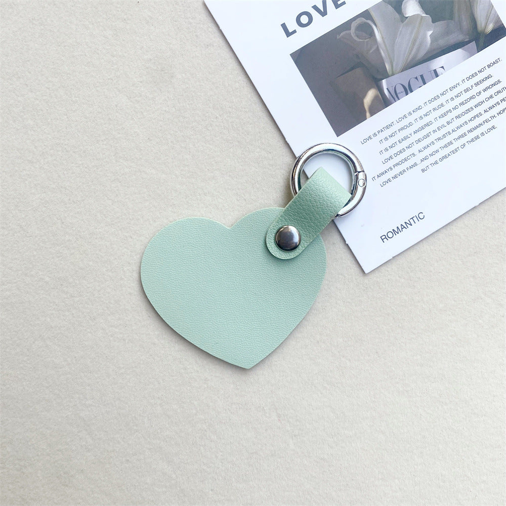 Elegant leather heart bag charm. Stylish accessory for purses & backpacks. Perfect gift idea.