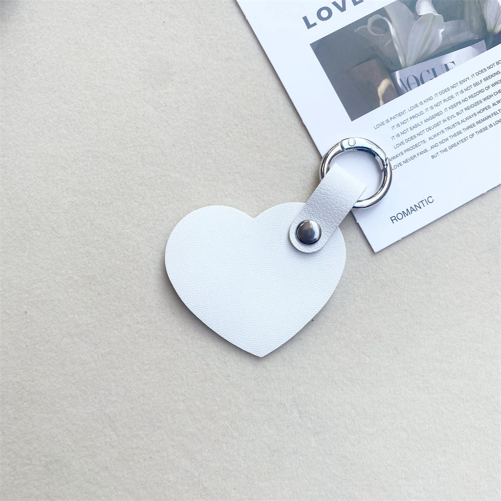 Vibrant red leather heart keychain. Durable & charming keyring for keys or a stylish bag accessory.