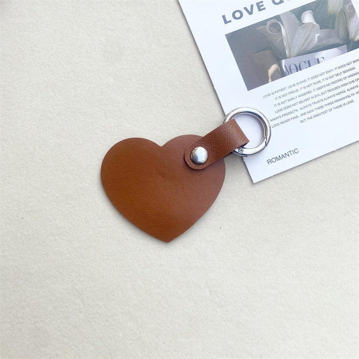 Stylish leather heart bag & key charm. Elegant and durable accessory. Perfect gift for any occasion.