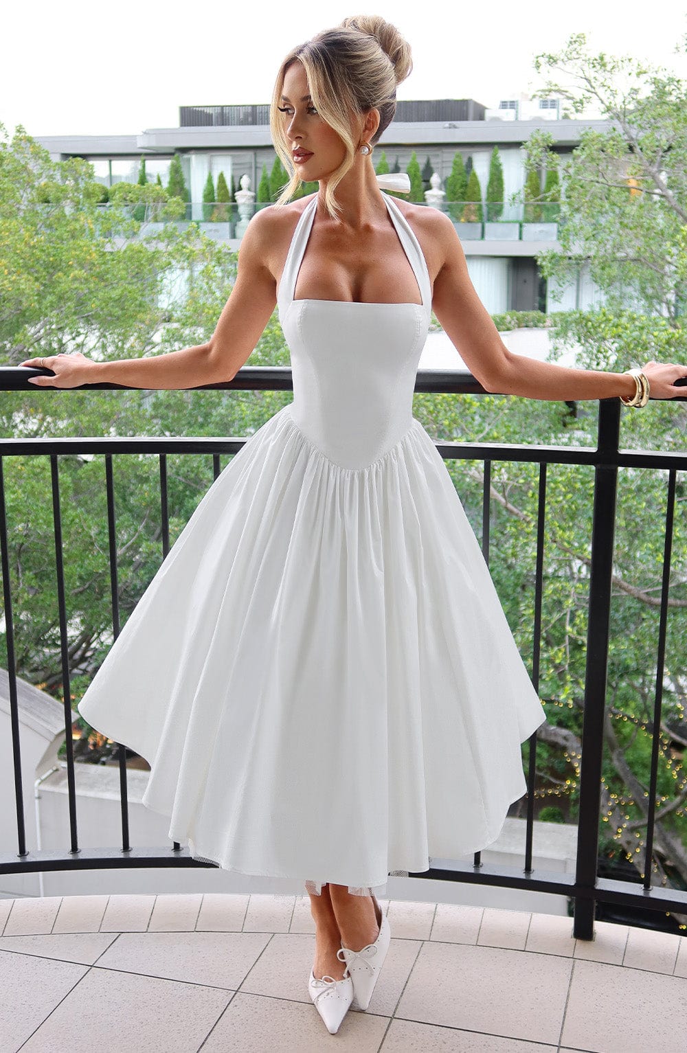 Chic black halter midi dress, perfect for wedding guests. Elegant women's formal wear.