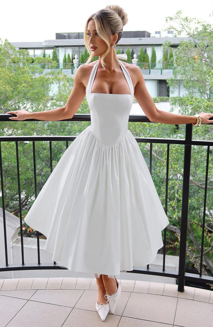 Chic black halter midi dress, perfect for wedding guests. Elegant women's formal wear.