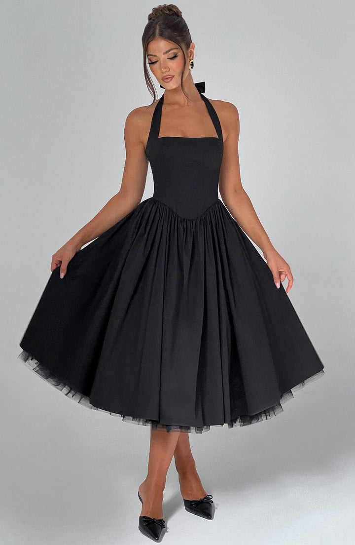 White midi dress with a halter neckline. Elegant women's formal wear for wedding guests and parties.