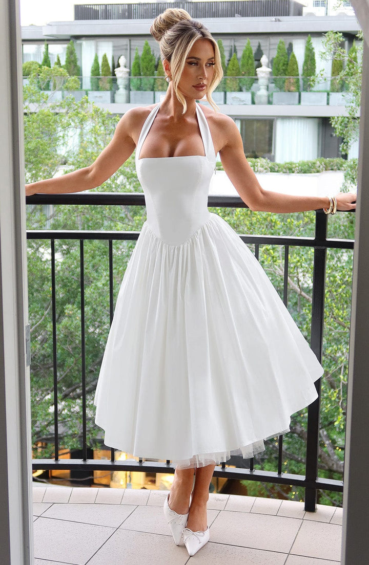 Elegant white halter midi dress for women. Ideal for wedding guests, cocktail parties, or evening events.