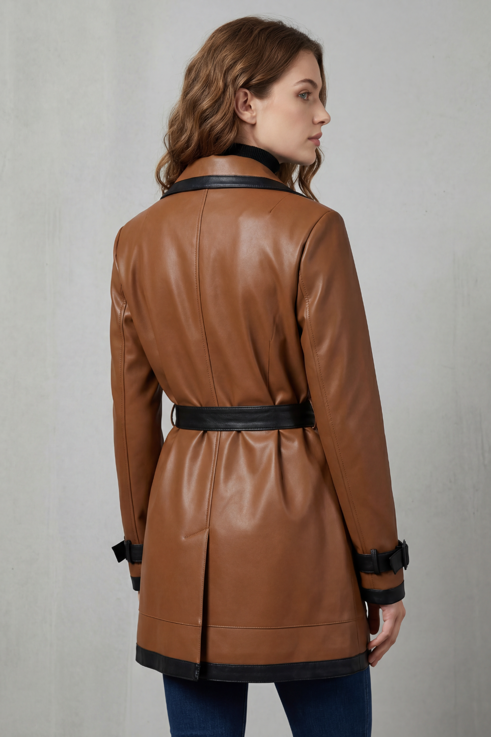 Sophisticated women's dark brown trench coat with contrast trim. A chic, belted long jacket for elegant fall fashion.
