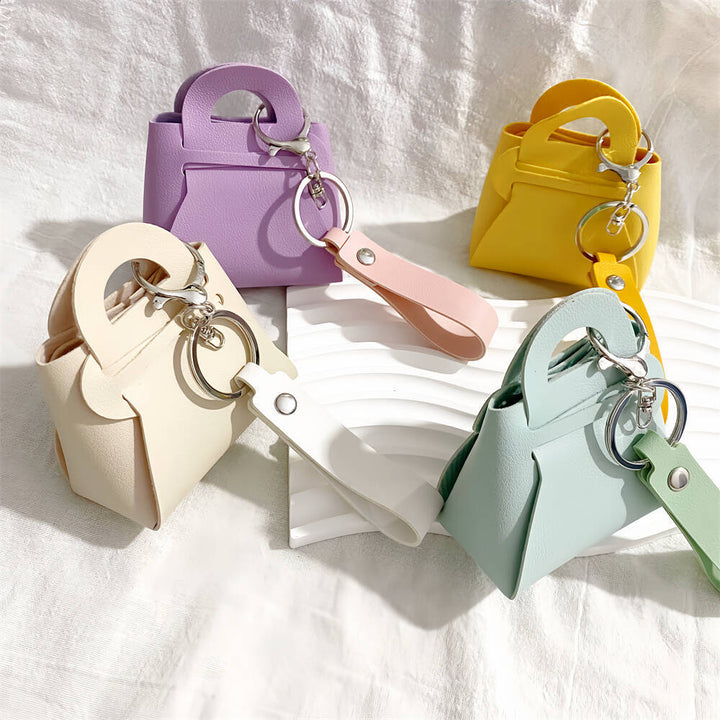 Sunny yellow miniature handbag keychain. Fashionable faux leather bag charm for women.