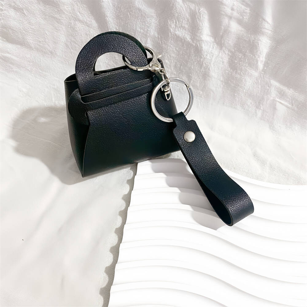 Chic faux leather miniature handbag keychain, a women's fashion accessory. Perfect for keys & bags.