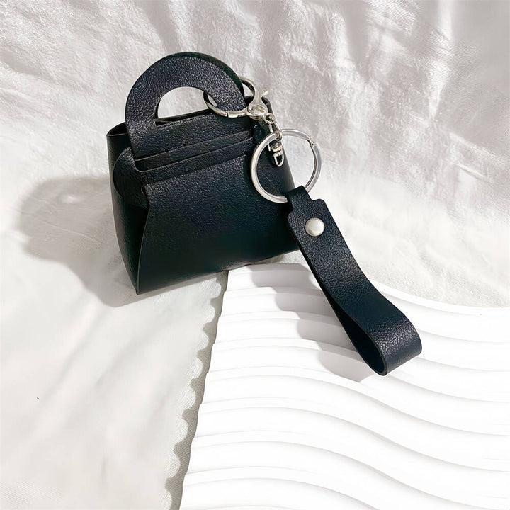 Chic faux leather miniature handbag keychain, a women's fashion accessory. Perfect for keys & bags.