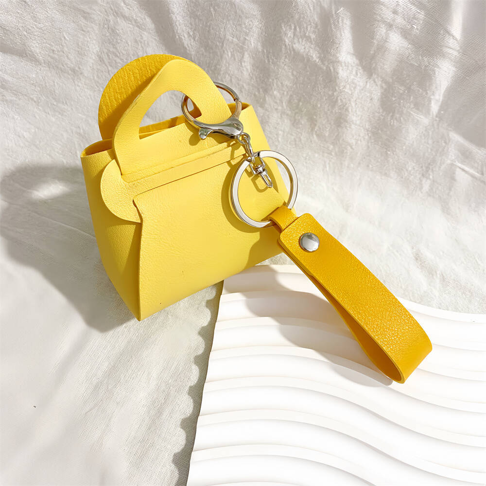 Unique women's gift: stylish faux leather miniature handbag keychain. A charming accessory.
