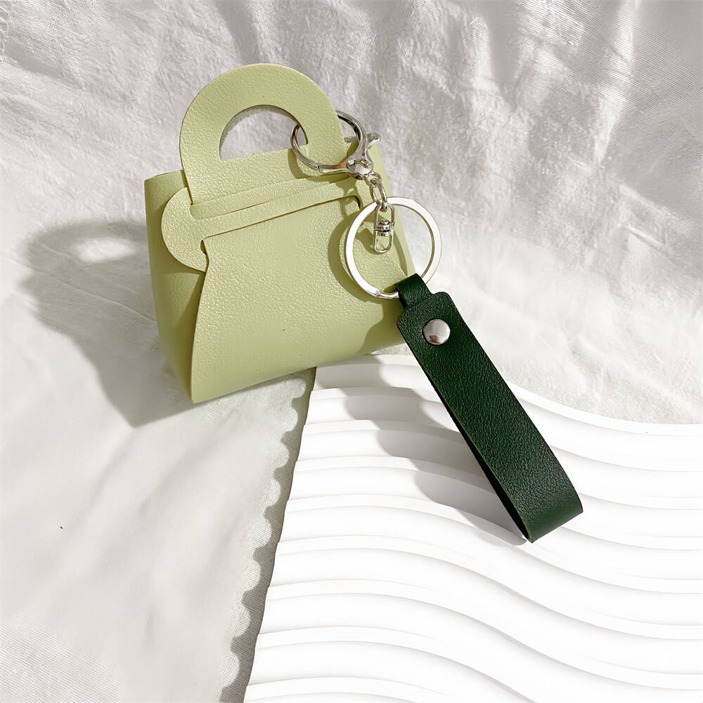 Close-up of a stylish faux leather mini handbag keychain. Perfect women's accessory for keys.