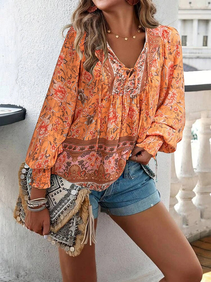 Chic women's floral summer blouse with vibrant print; lightweight and stylish short sleeve top.