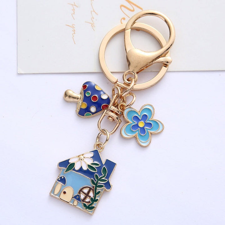 Cute women's floral house charm keychain with enamel details, ideal for keys or handbags.