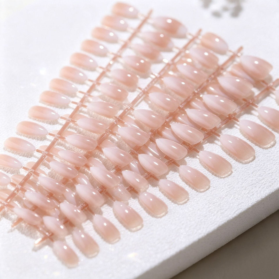 Women's stick-on nail art set with chic nude-pink designs, providing a simple, quick, and beautiful manicure solution.