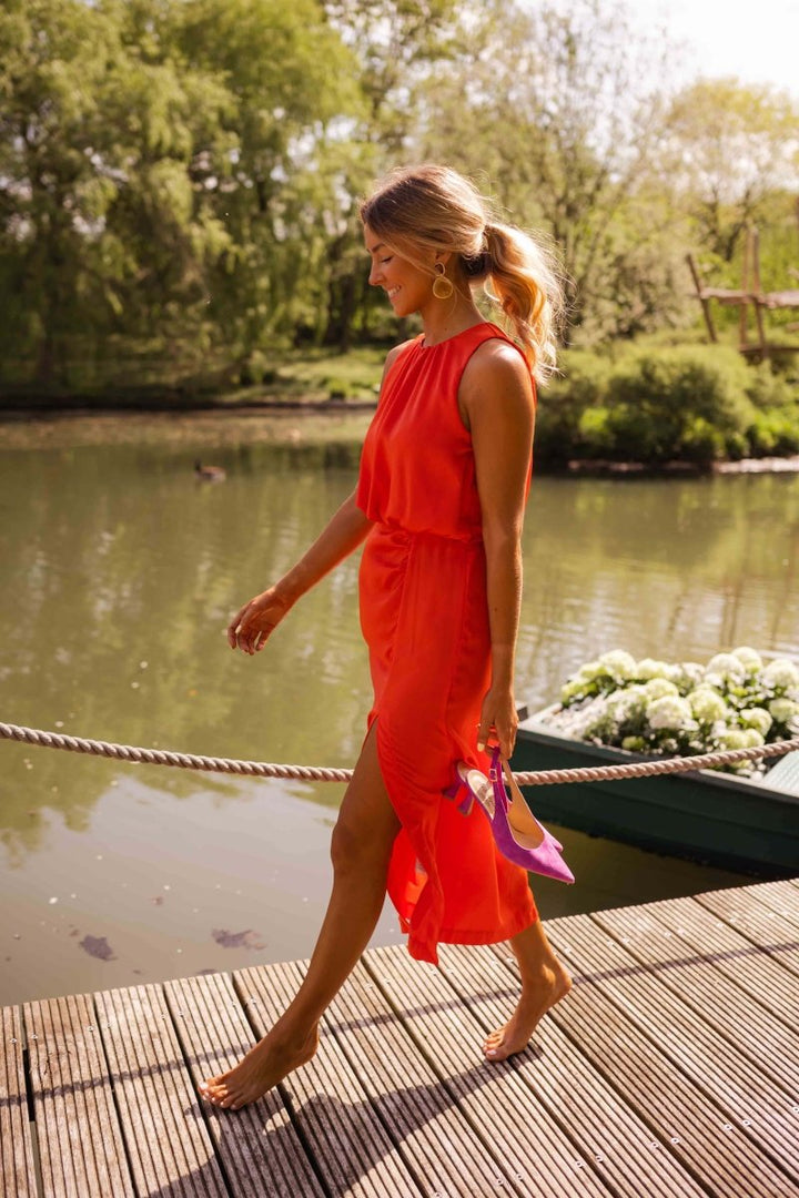 Stylish women's sleeveless midi dress, featuring a chic front split. Versatile for summer fashion, day or evening.