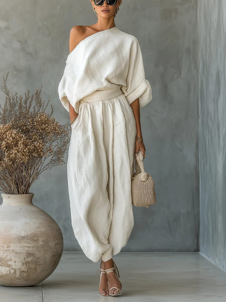 Chic women's beige off-shoulder top and tapered pants matching set. Comfortable, versatile loungewear for elegant style.
