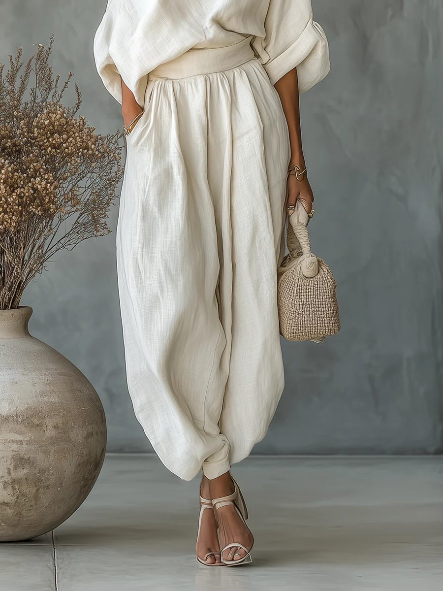 Elegant women's beige off-shoulder top with tapered trousers. Comfortable matching pants set for a versatile chic look.