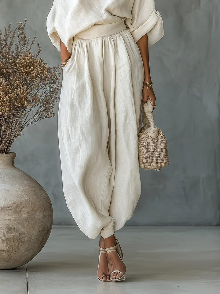 Elegant women's beige off-shoulder top with tapered trousers. Comfortable matching pants set for a versatile chic look.