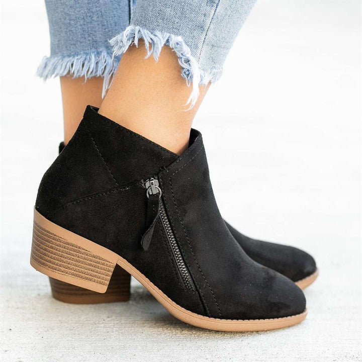 Chic women's zipper ankle boots, perfect for versatile autumn, winter, and spring fashion outfits.