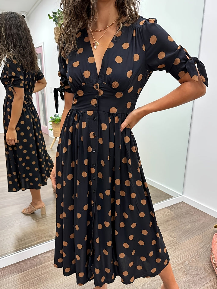 Chic Women's black polka dot midi dress with V-neck, A-line silhouette & tie sleeves. Elegant for spring parties.