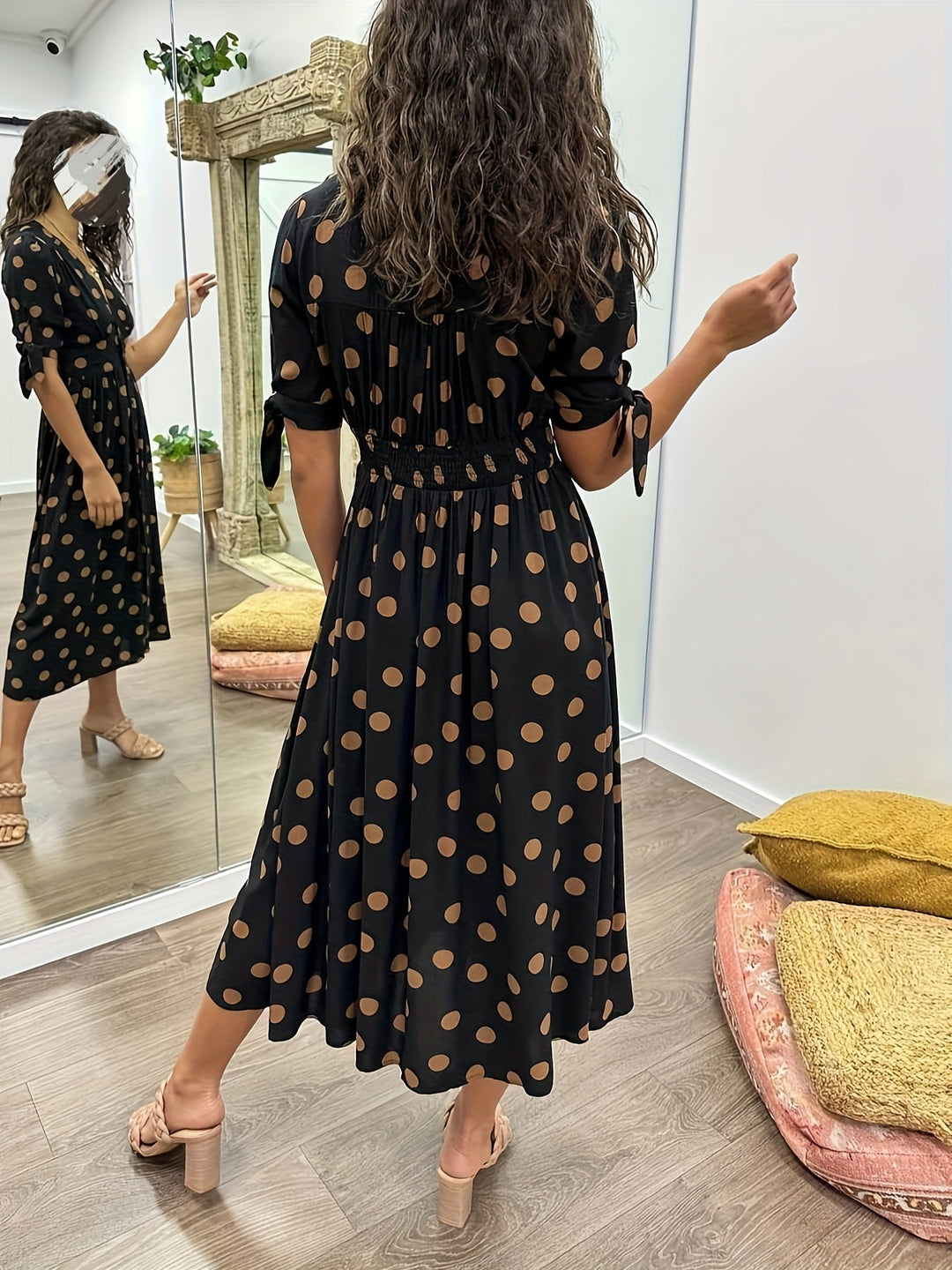 Versatile black polka dot midi dress for women, perfect for elegant parties, casual outings, or sophisticated wear.