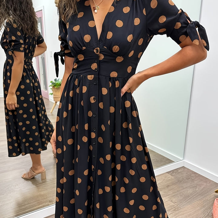 Sophisticated women's black polka dot midi dress. Ideal elegant party wear or casual spring outfit with tie sleeves.