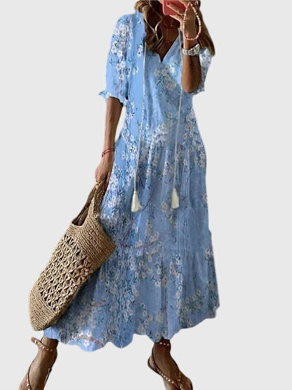 Elegant women's flowy summer dress with bohemian vintage style. Comfortable midi sundress for vacation or beach.