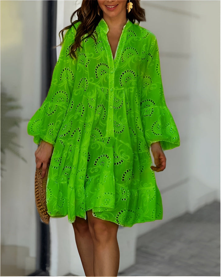 Stylish women's eyelet Broderie Anglaise tiered mini dress, long-sleeved shirt style, perfect for summer casual wear.