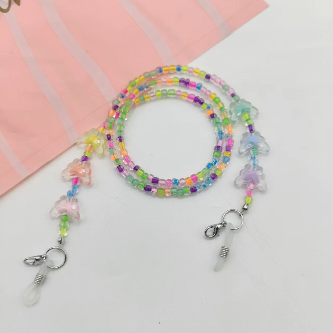 Close-up of a delicate butterfly glasses chain. Trendy women's accessory for secure and stylish eyewear holding.