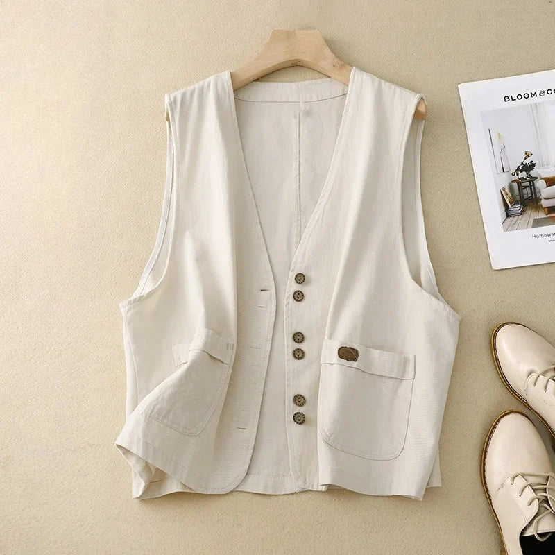 Chic women's button-front vest with patch pockets, a v-neck & relaxed fit. Versatile sleeveless top for summer.