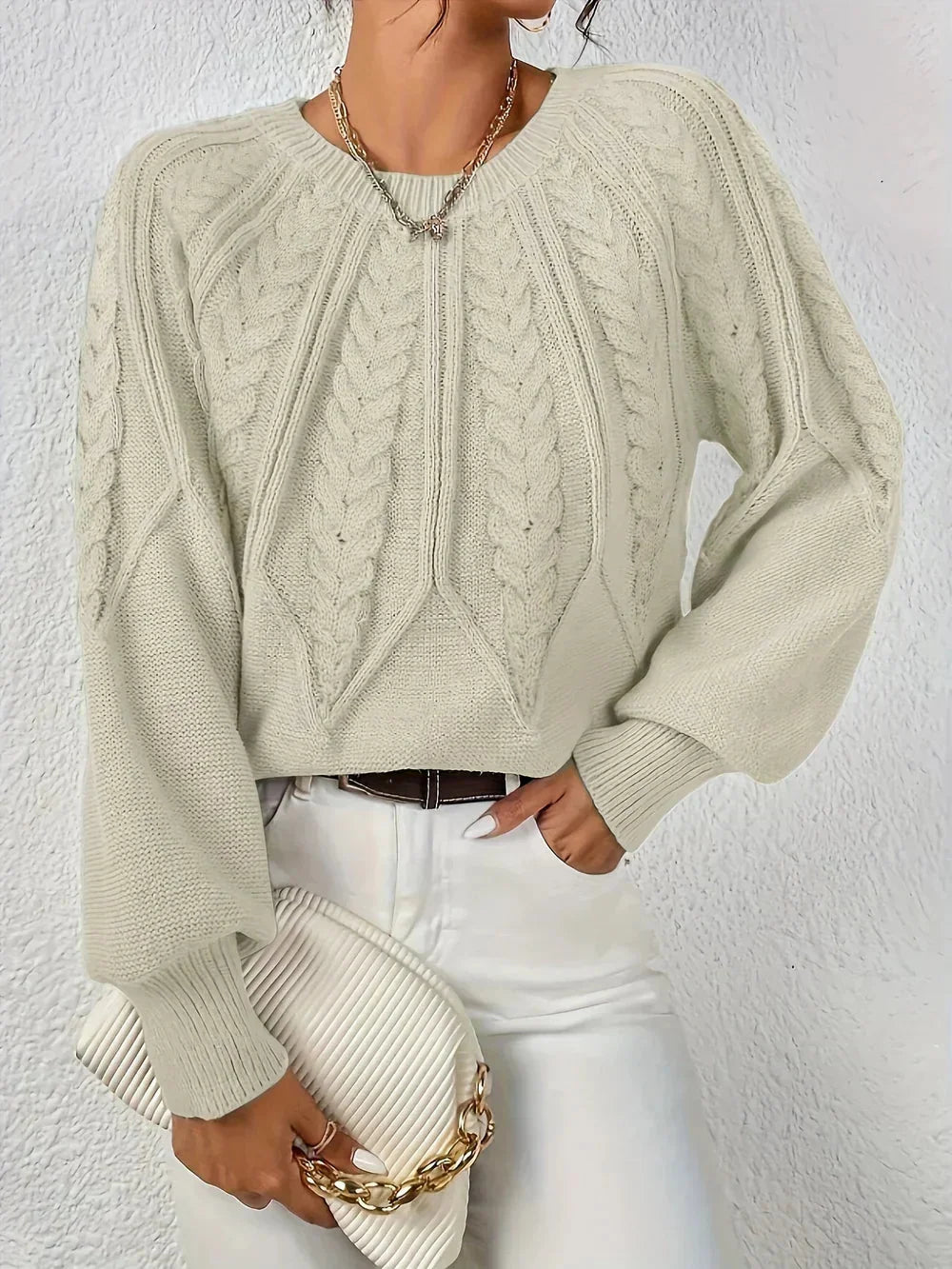 Cozy women's cable knit sweater. Long voluminous sleeves & classic crew neck design for chic autumn & winter style.