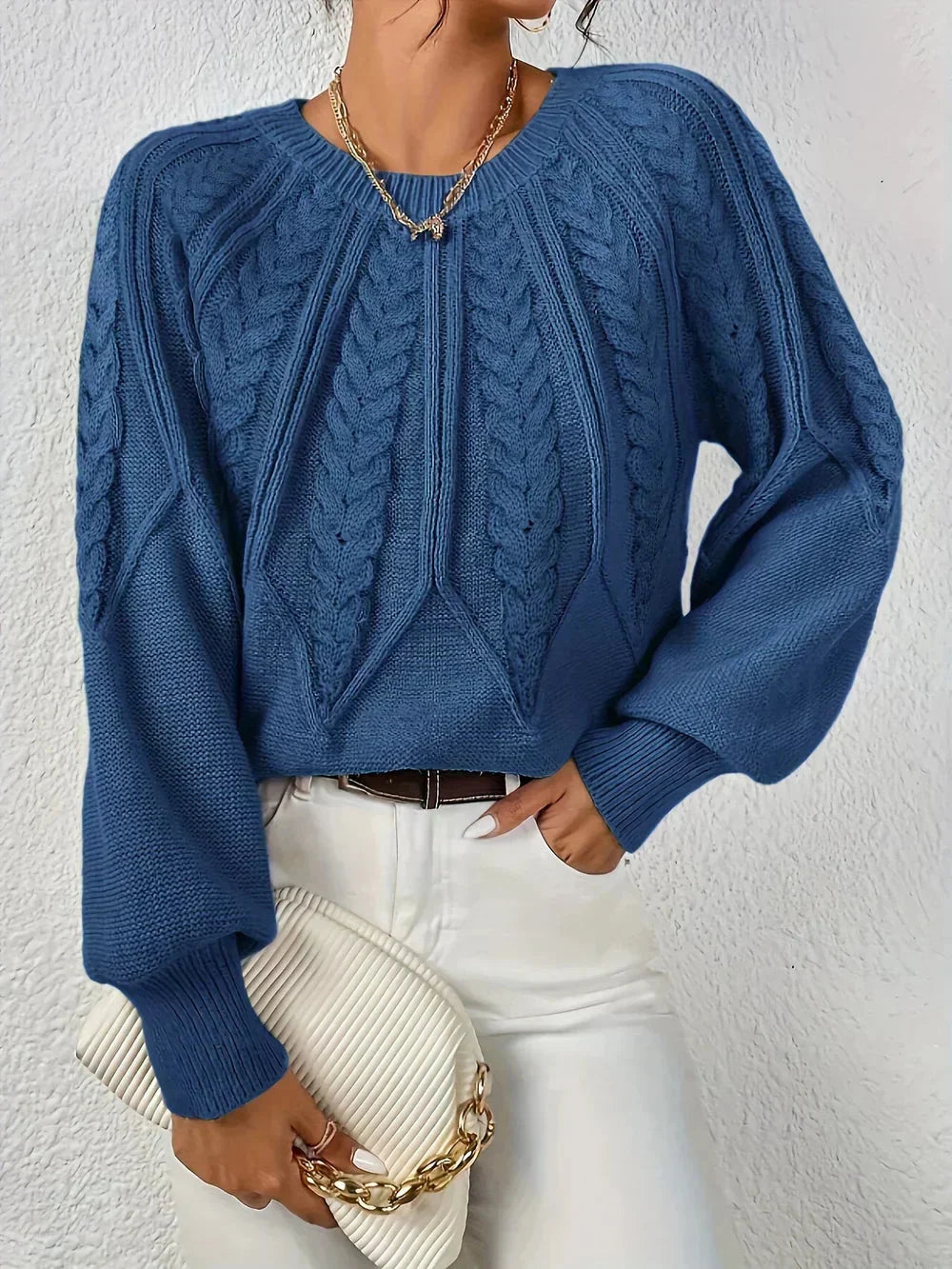 Detailed view of a women's cable texture pullover, highlighting the intricate knit pattern and soft fabric.