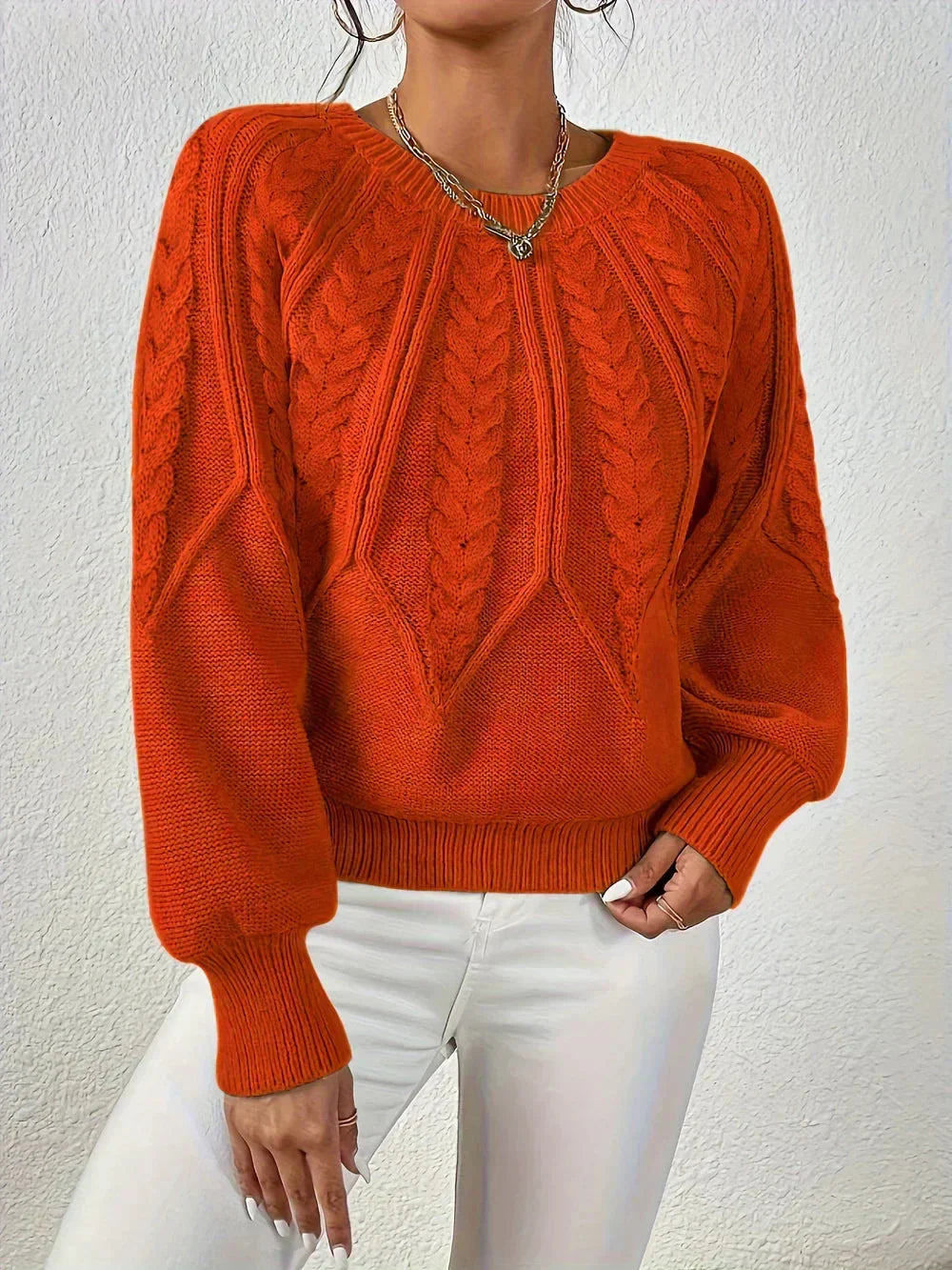 Stylish women's pullover sweater with voluminous long sleeves and a classic crew neck, ideal for elegant fall outfits.