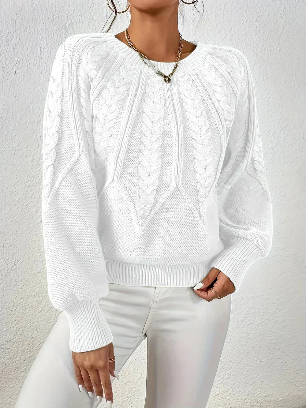 Soft women's crew neck pullover sweater, featuring a classic cable texture and modern voluminous long sleeves.