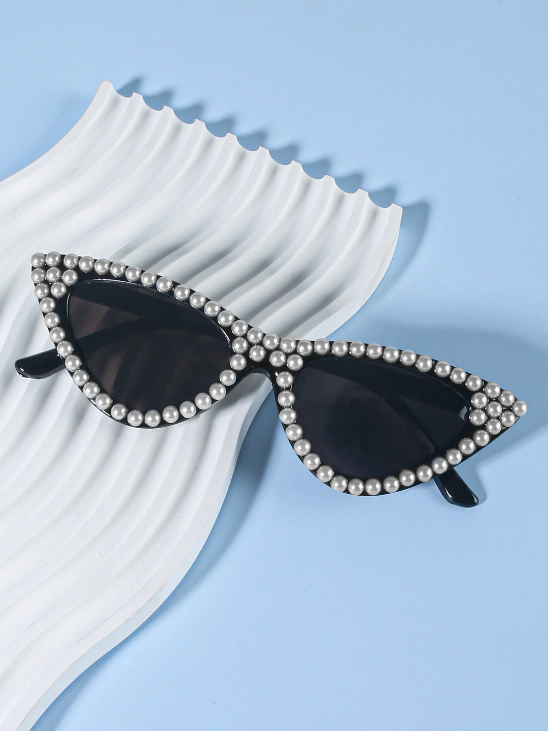 Fashion-forward cat-eye sunglasses for women, with rhinestone accents for a glamorous style.