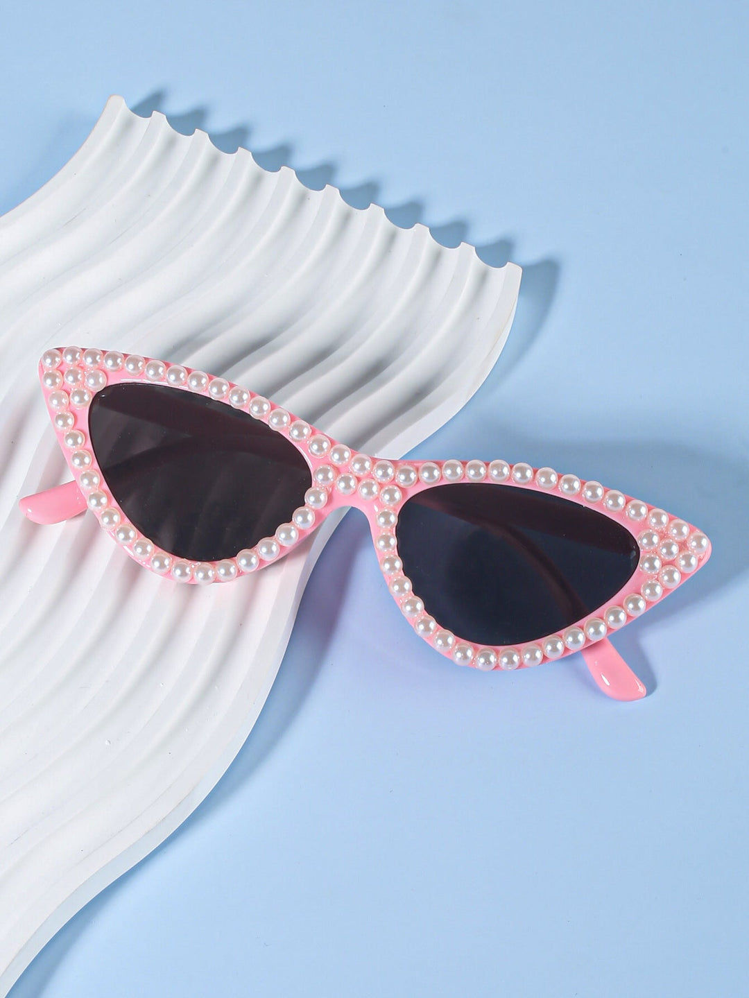 Chic women's cat-eye sunglasses with delicate rhinestone accents, perfect for stylish eye protection.