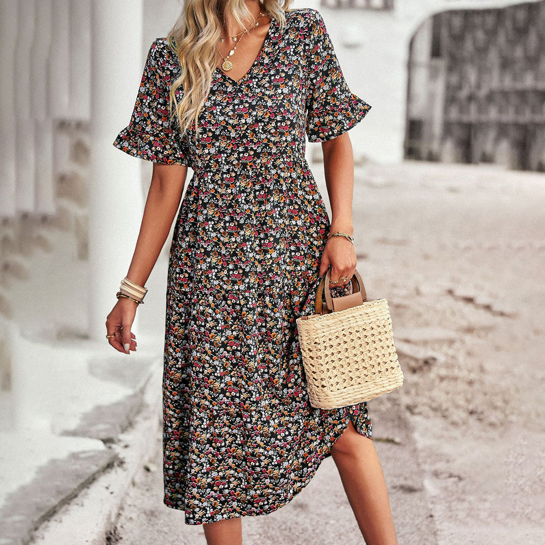 Elegant women's midi dress with vibrant floral print, ideal for warm weather or casual summer days.