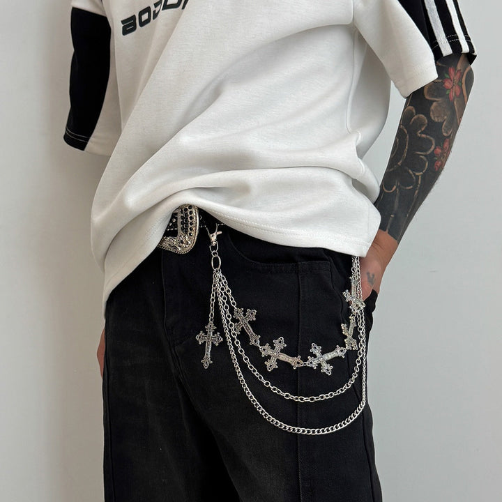 White elegant chain belt with intricate cross pendants for women. Stylish jewelry belt.