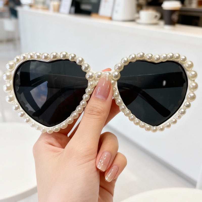 Unique women's heart sunglasses, embellished with rhinestones, perfect for a chic festival style.